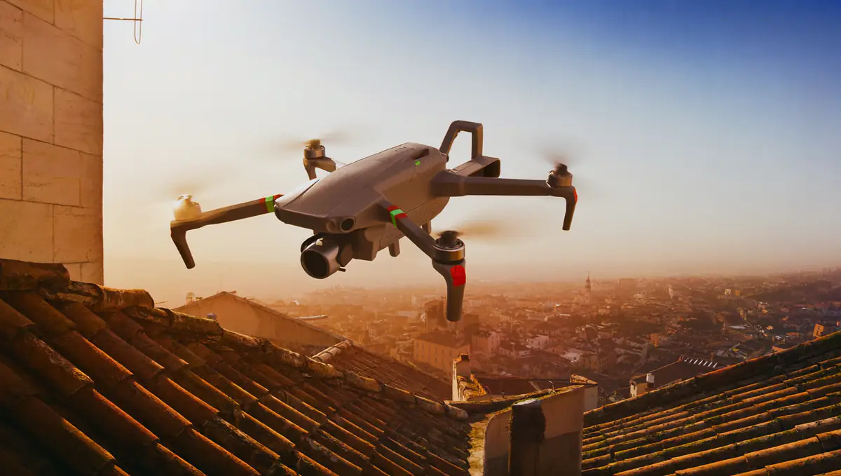 Small drone hovering above terracotta rooftops in Porto at golden hour