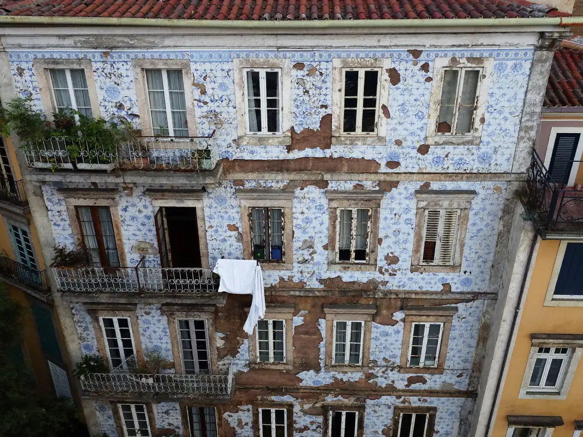 Old Porto apartment building facade with tiles, windows and balconies seen at upper floor height