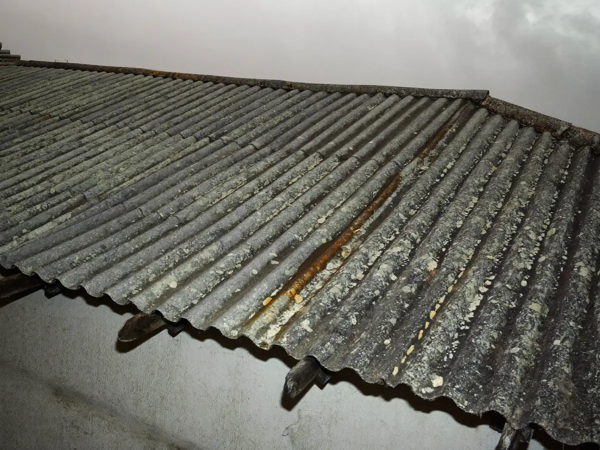 Old weathered corrugated fibre-cement roof sheets on a rural Portuguese building